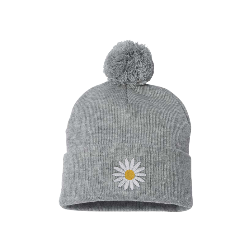 Heather gray cuffed beanie with a Pom Pom. It has a white embroidered daisy