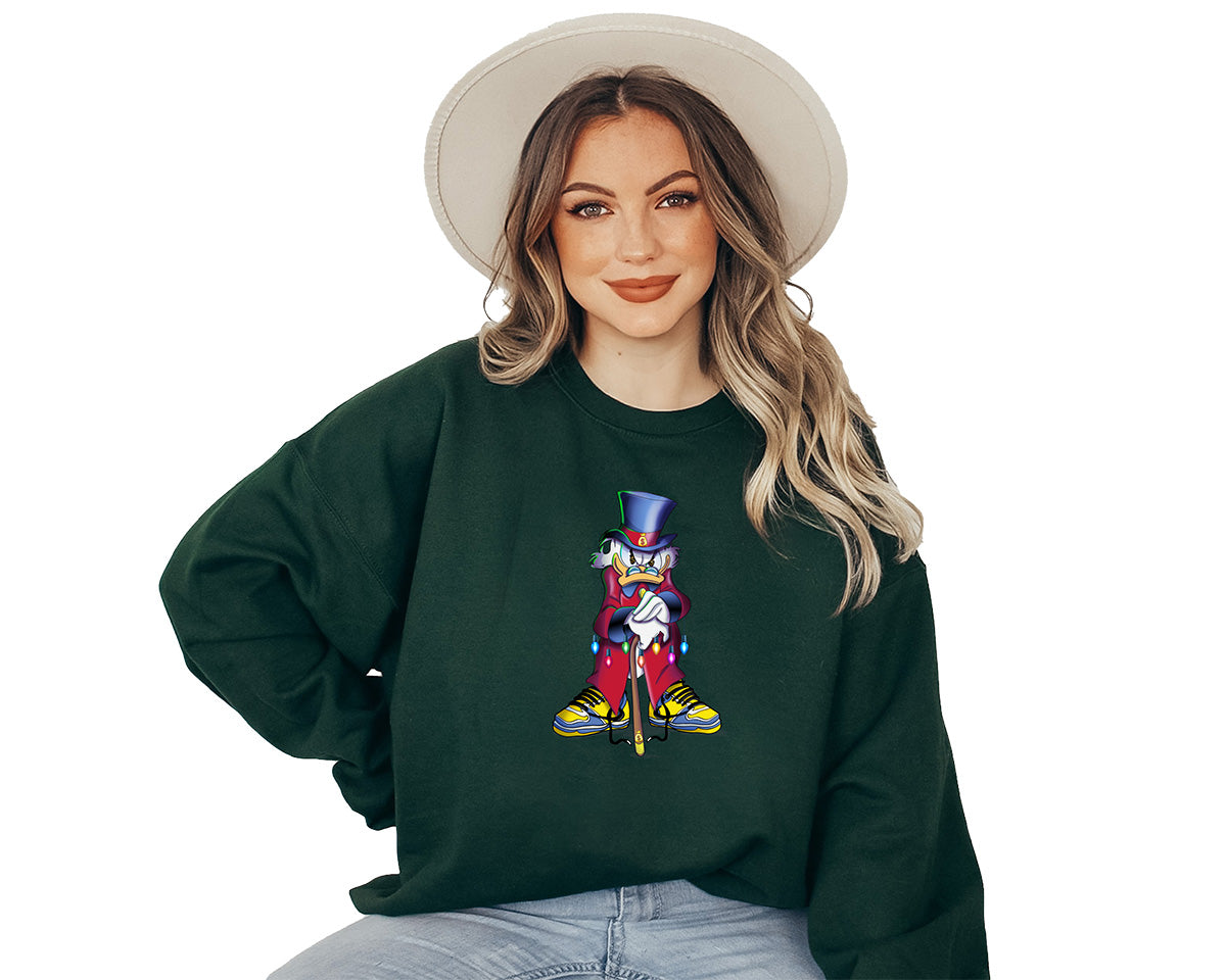 Woman wearing a green forest sweatshirt with a large screen printed of the scrooge McDuck. He is angry standing leaning on his cane.