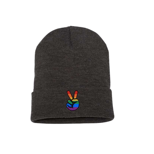 Dark Gray cuffed beanie. It has an embroidered on the cuff with the Pride colors peace sign