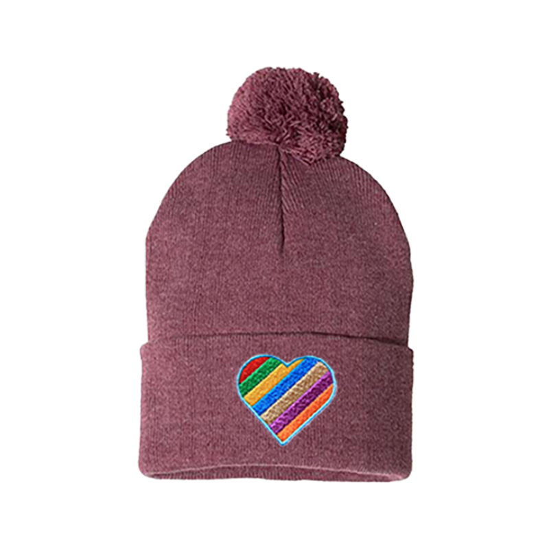 Heather cardinal cuffed beanie with a pom pom. It has a heart embroidered with the  Pride colors on the cuff