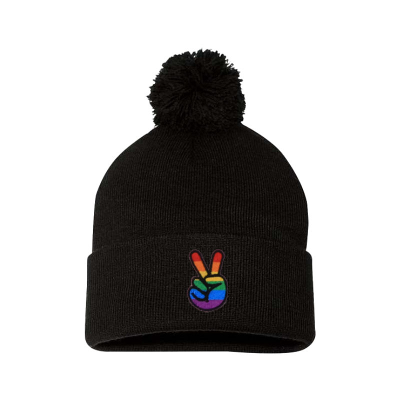 Black cuffed beanie with a pom pom. It has embroidered the sign of peace on the cuff with the Pride colors